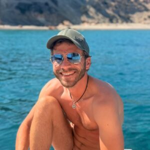 Daniel smiling while on the boat