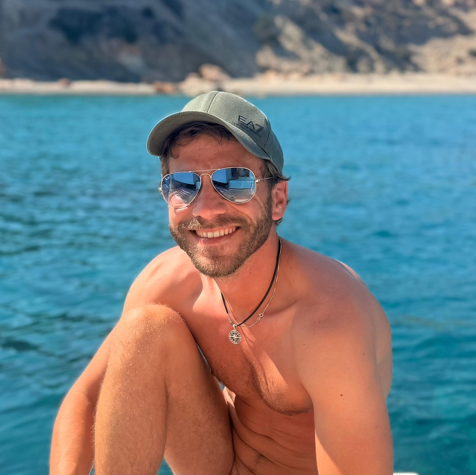 Daniel smiling while on the boat